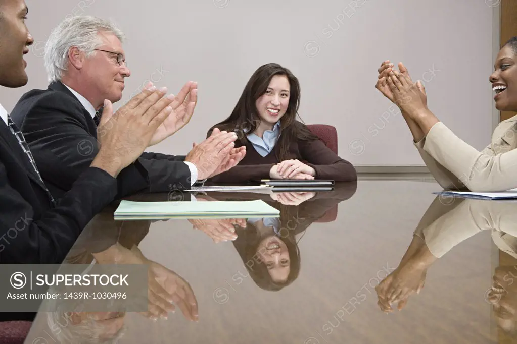 People clapping colleague