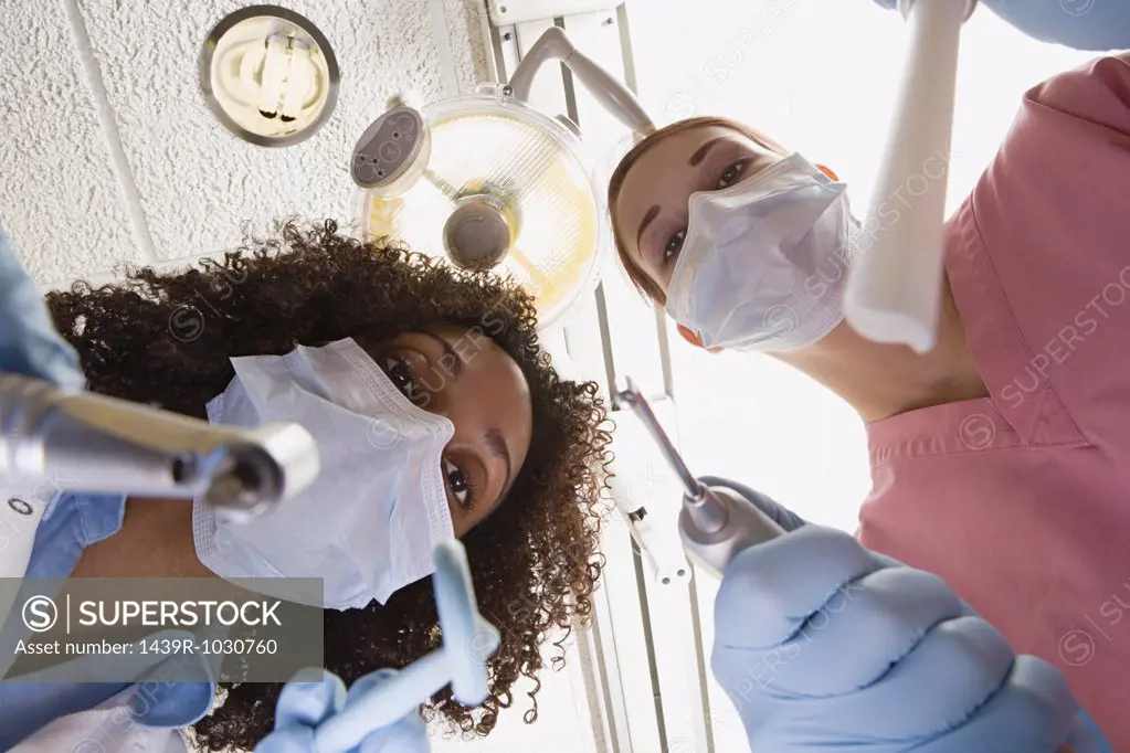 Low angle view of dentist and dental nurse