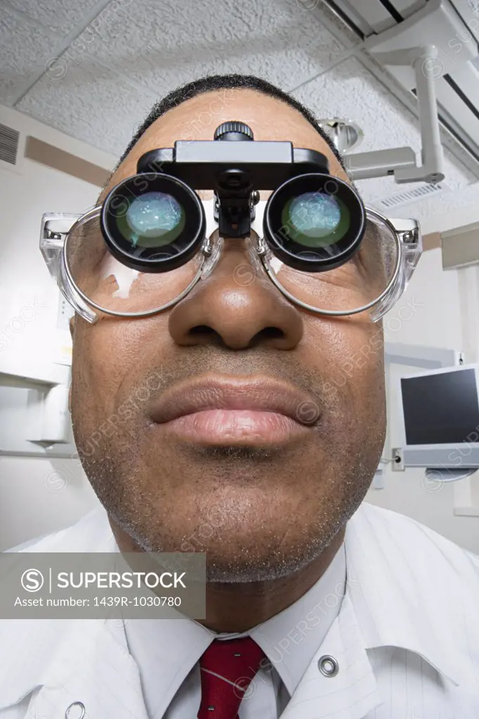 Dentist wearing dental binocular loupes