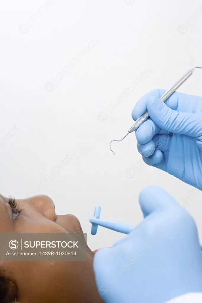 Boy having teeth examined