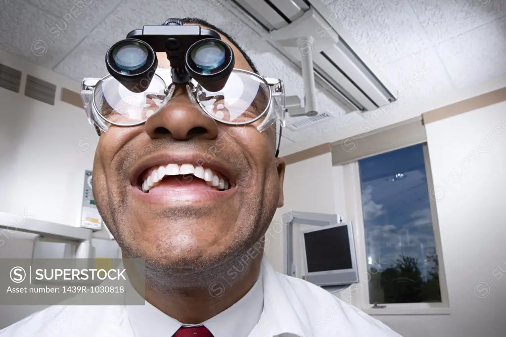 Dentist wearing dental binocular loupes