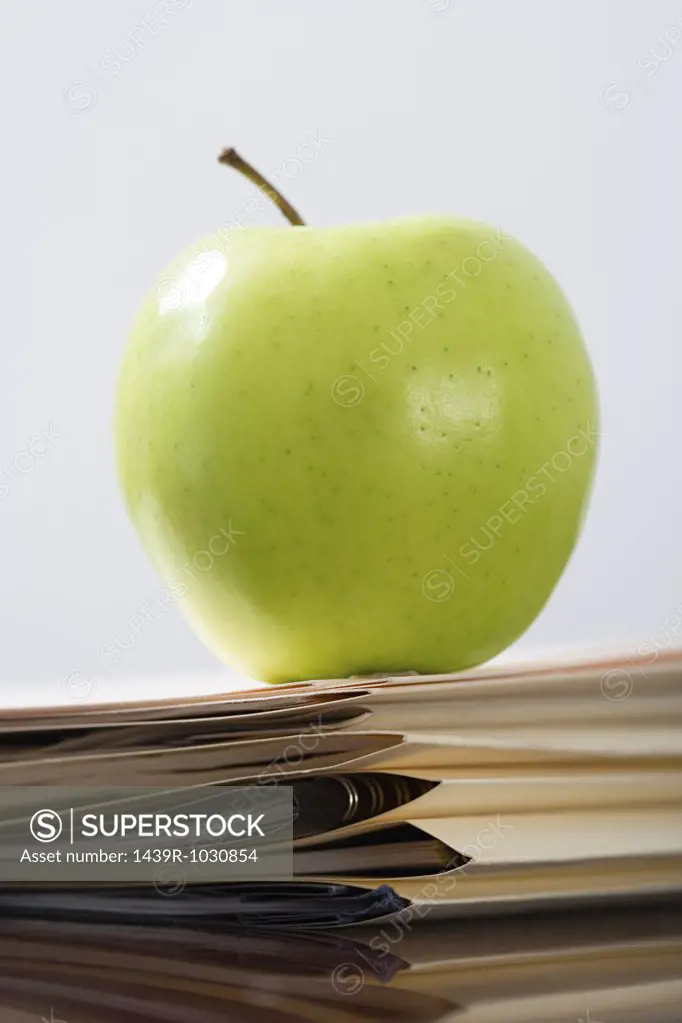 Apple on a stack of files
