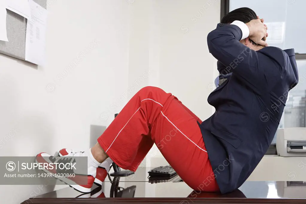 Businessman exercising in office