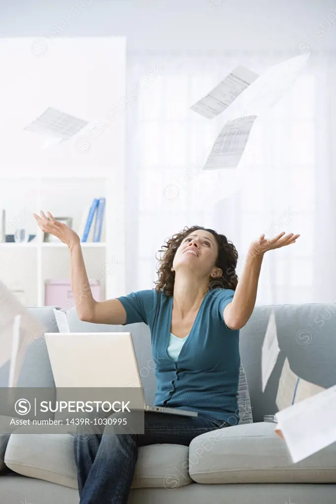 Woman surrounded by bills
