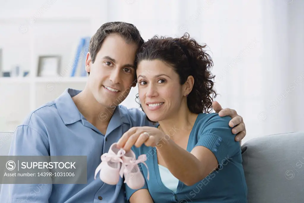 Couple holding a pair of baby booties
