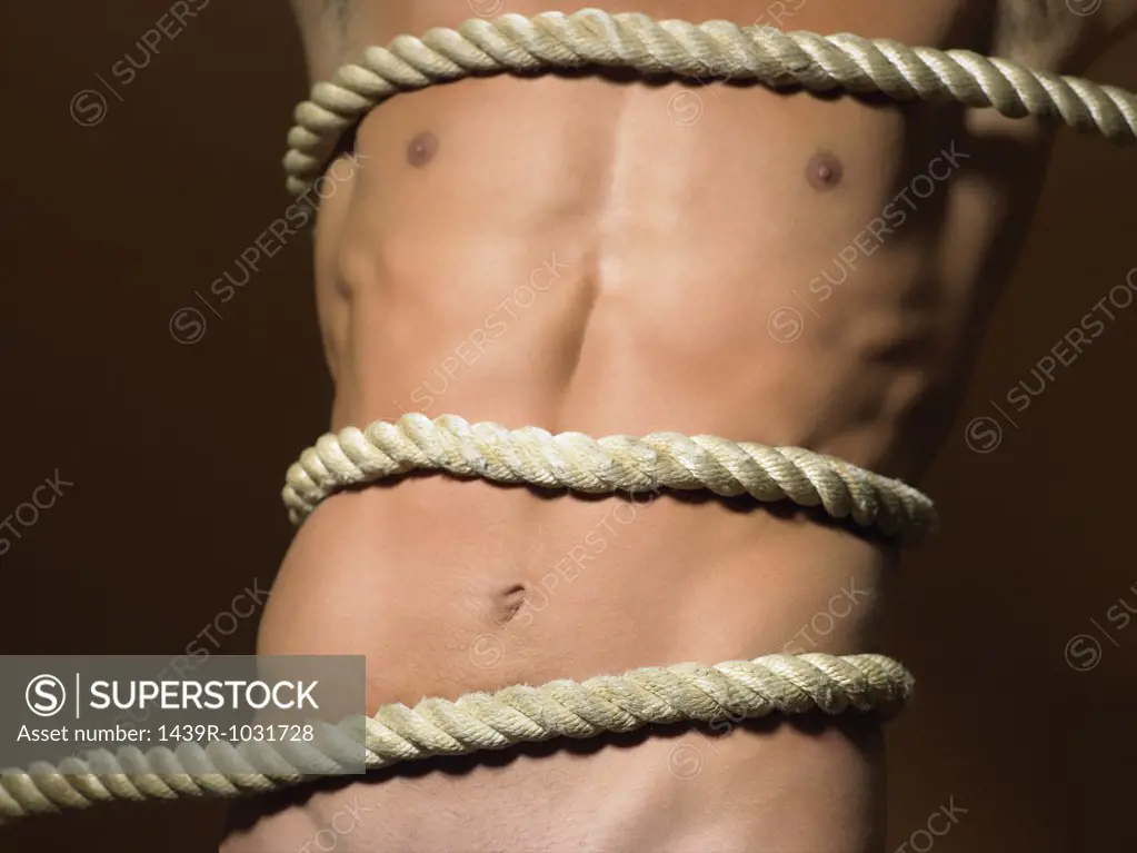 Rope tied around mans torso