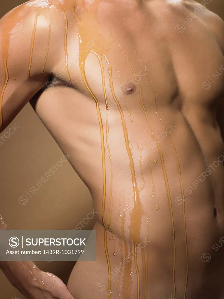 Honey dripping down a mans torso