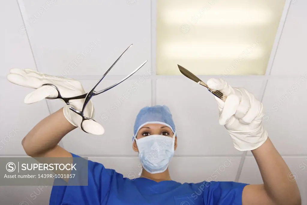 Surgeon with scalpel and clamp