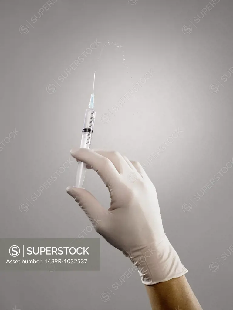 Person holding syringe