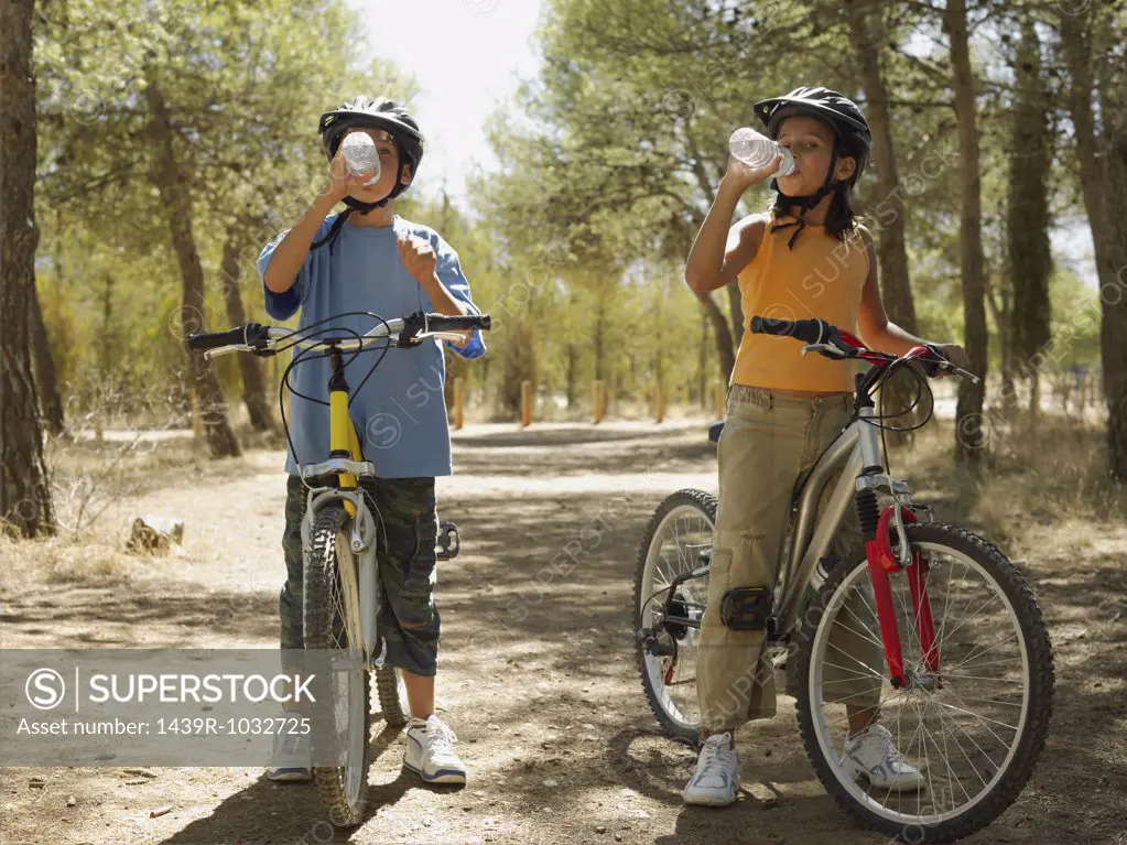 Kids on bikes drinking water