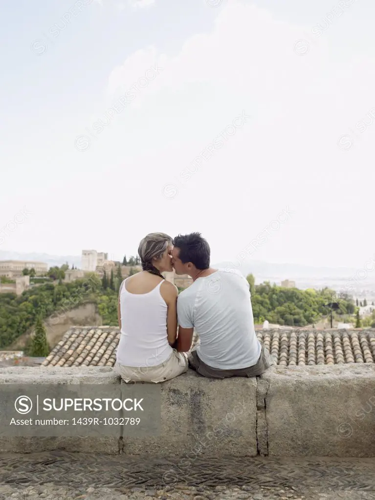 Couple on kissing on wall