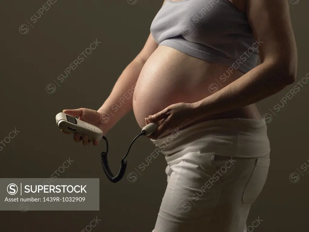 Pregnant woman checking babys pulse