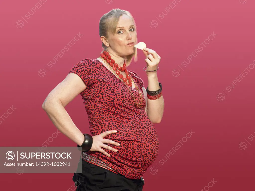 Pregnant woman eating a crisp