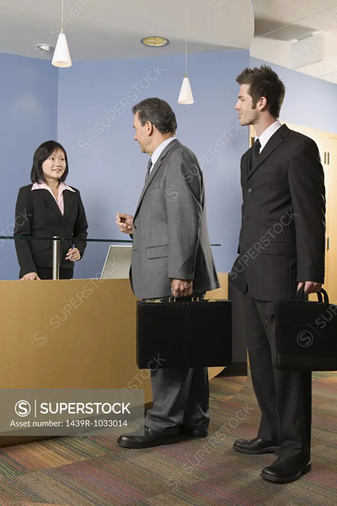 Businessmen at a reception desk