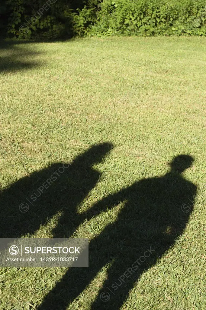 Shadows of a couple on a lawn