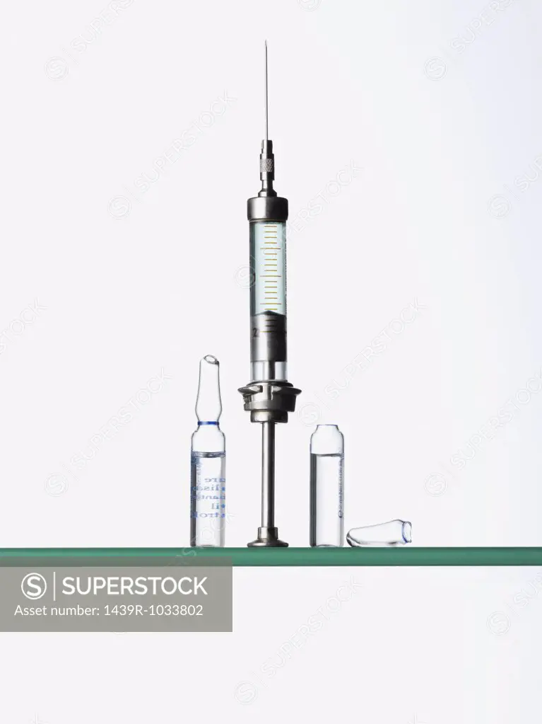 Syringe and medicine on shelf