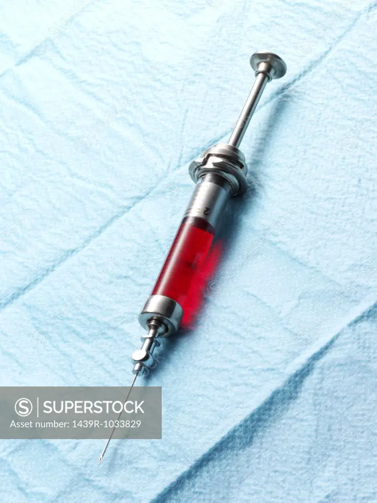 Syringe containing red liquid
