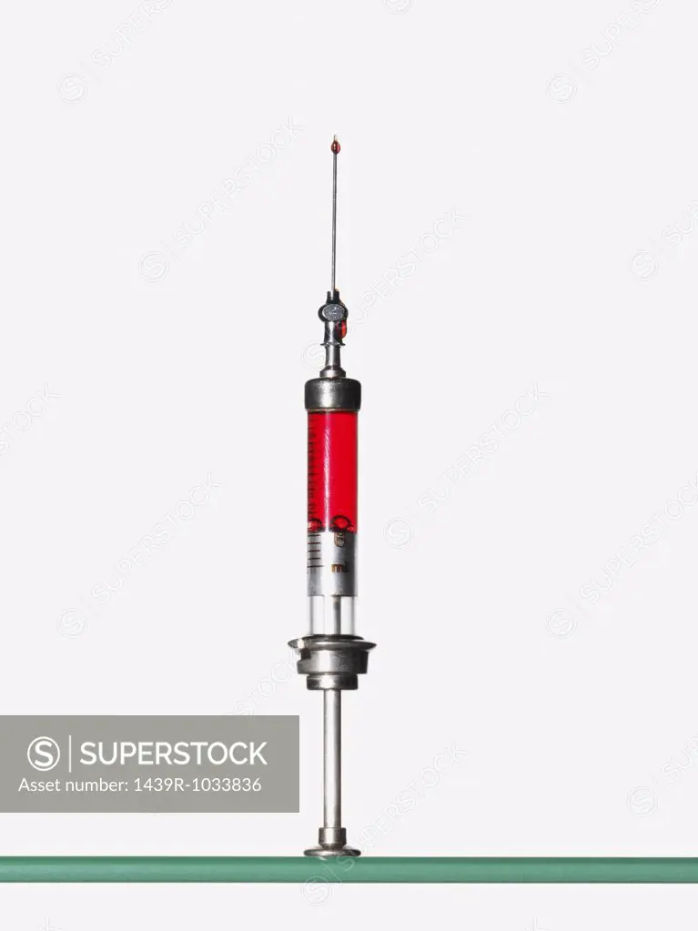 Syringe containing red liquid