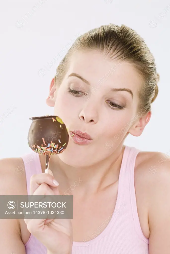 Woman eating chocolate apple
