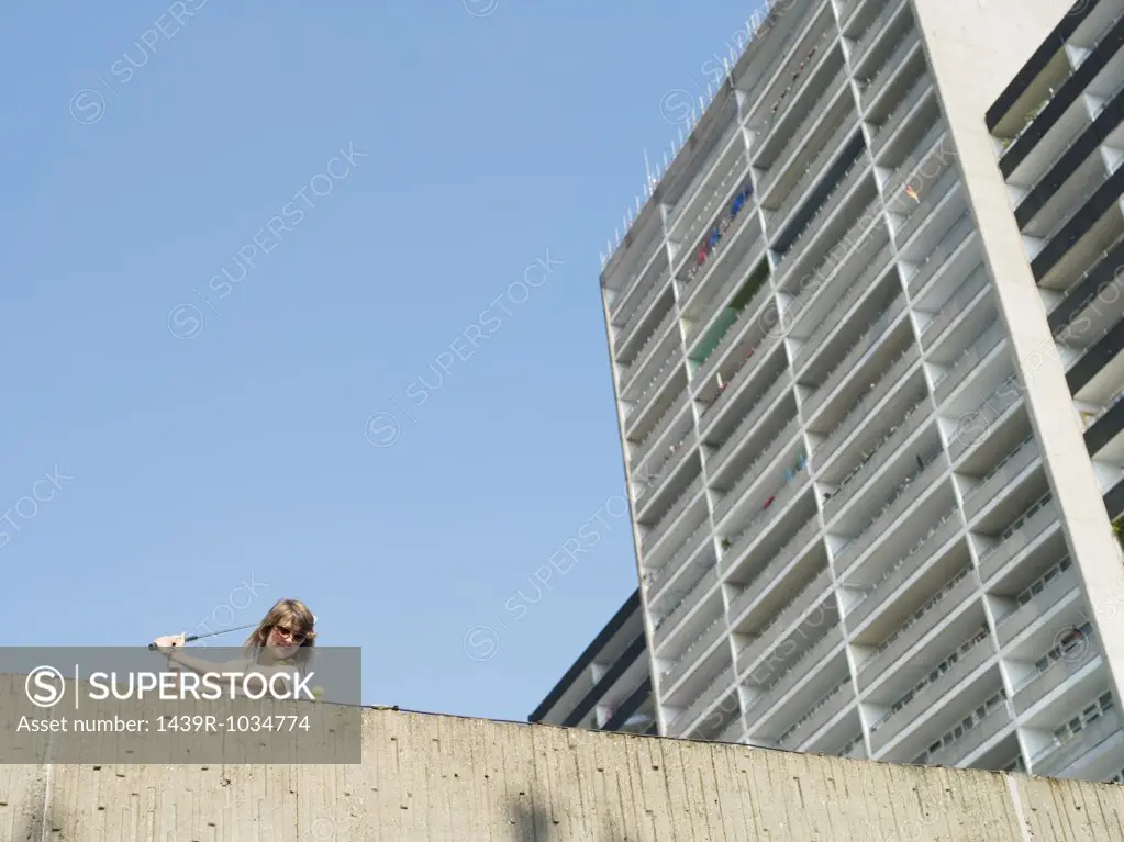 Woman playing urban golf