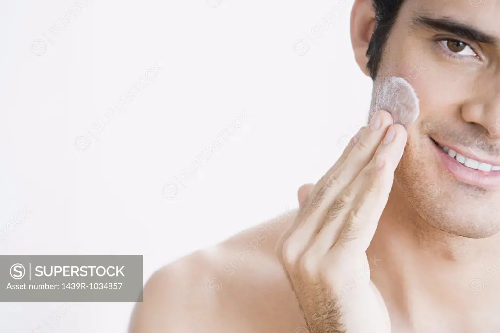 Man applying moisturiser