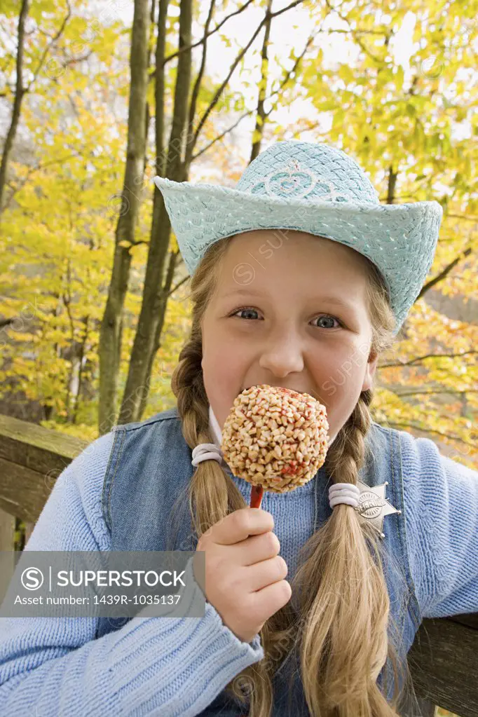 Girl eating a toffee apple
