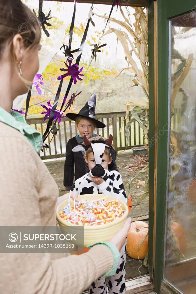 Woman with sweets for trick or treaters