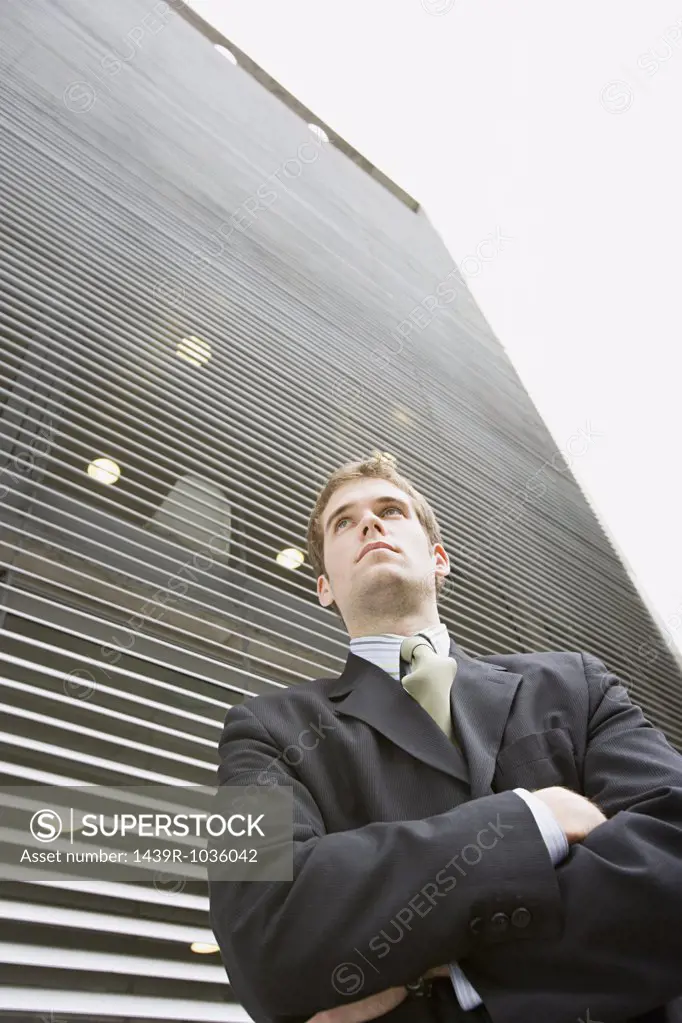 Young businessman looking up