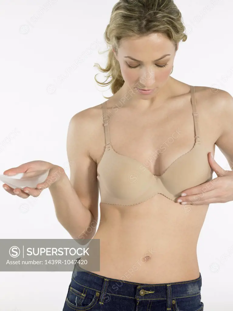Woman holding a breast implant