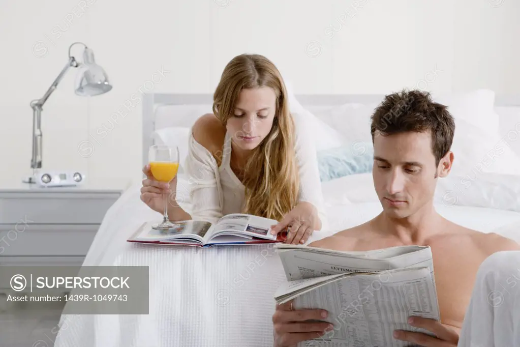 Couple reading in bedroom