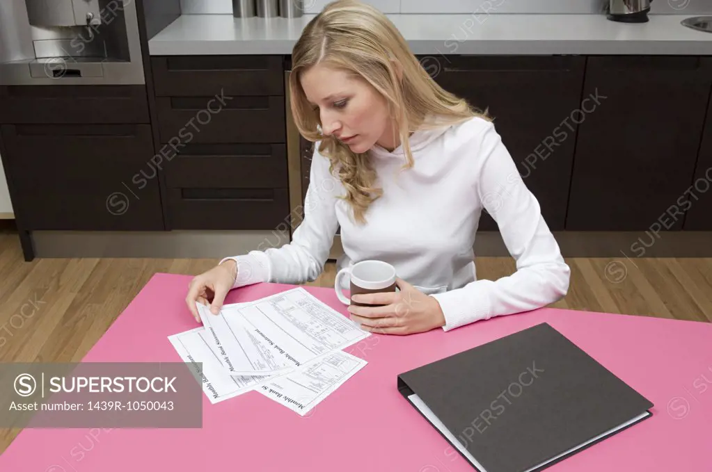 Woman reading bank statements