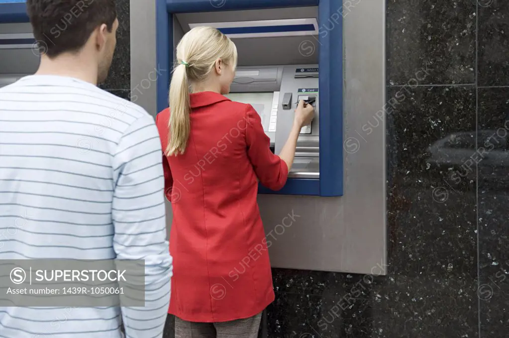 Woman using cash machine