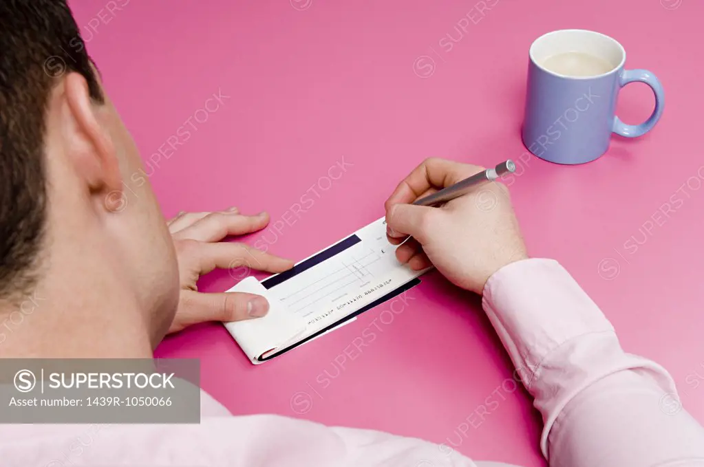 Man signing cheque