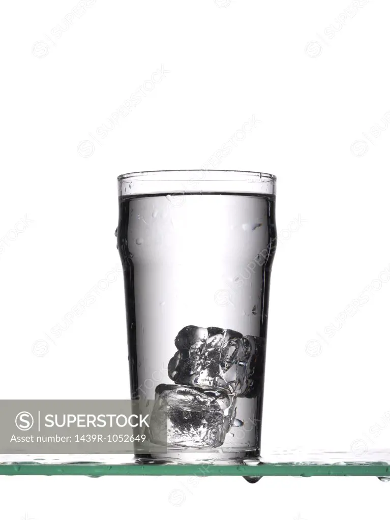 Ice cubes in glass of water