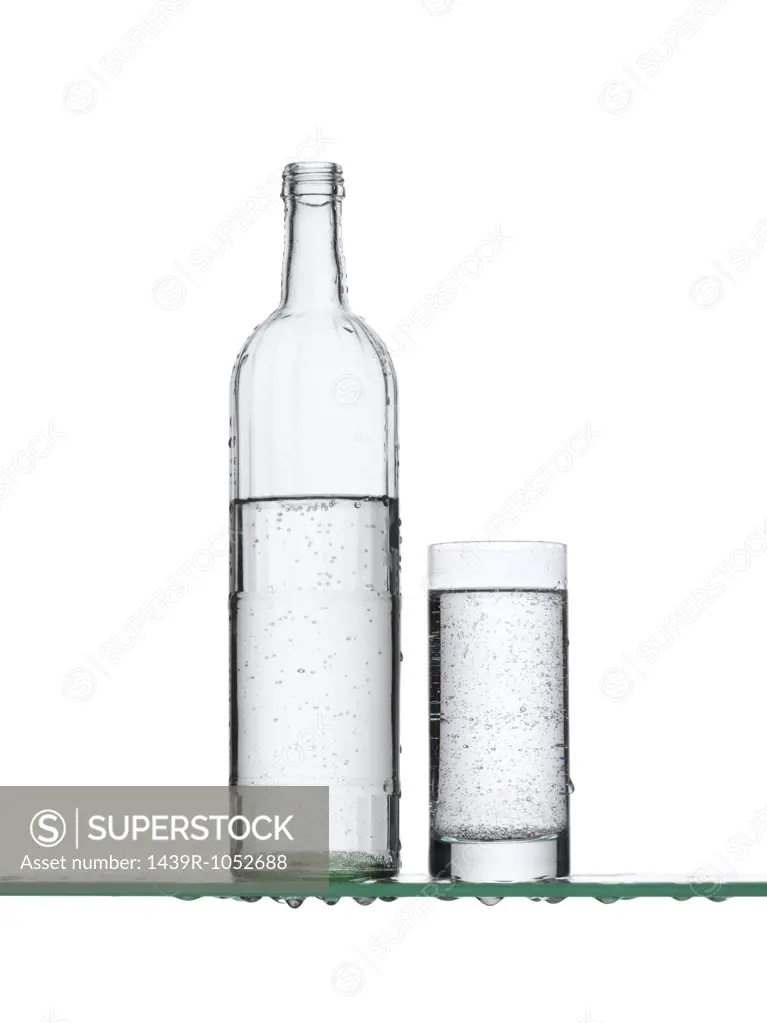 Sparkling water in a bottle and a glass