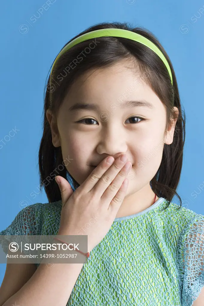 Girl with hand over her mouth