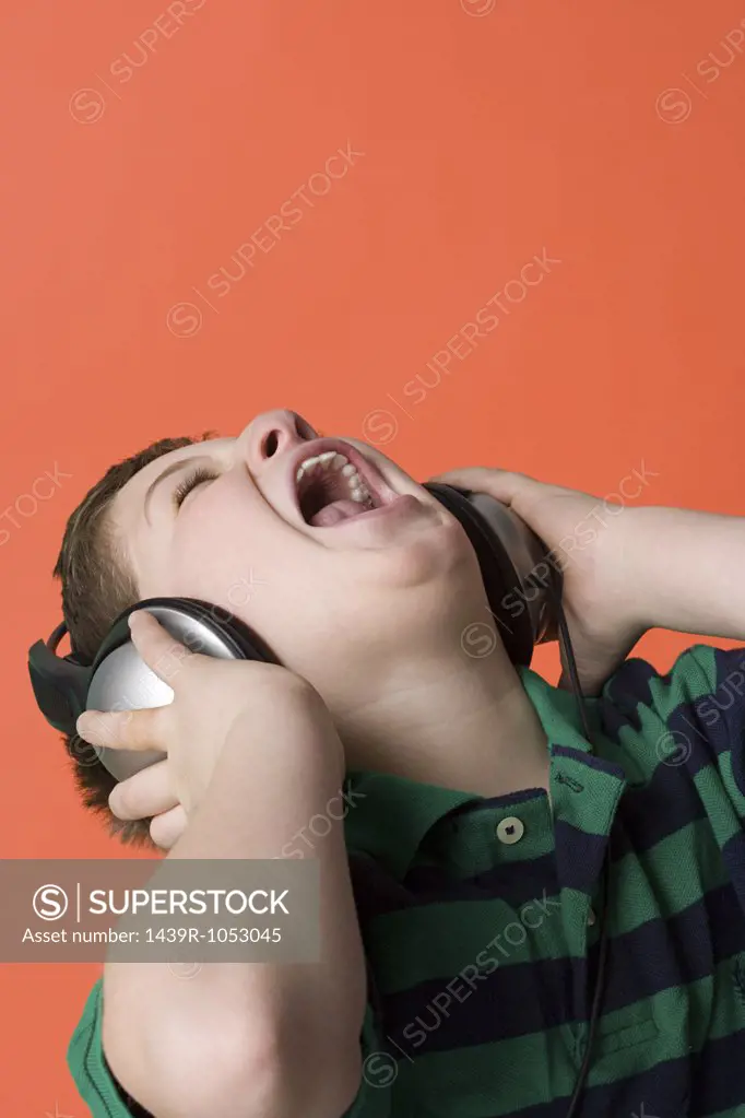 Boy wearing headphones and singing