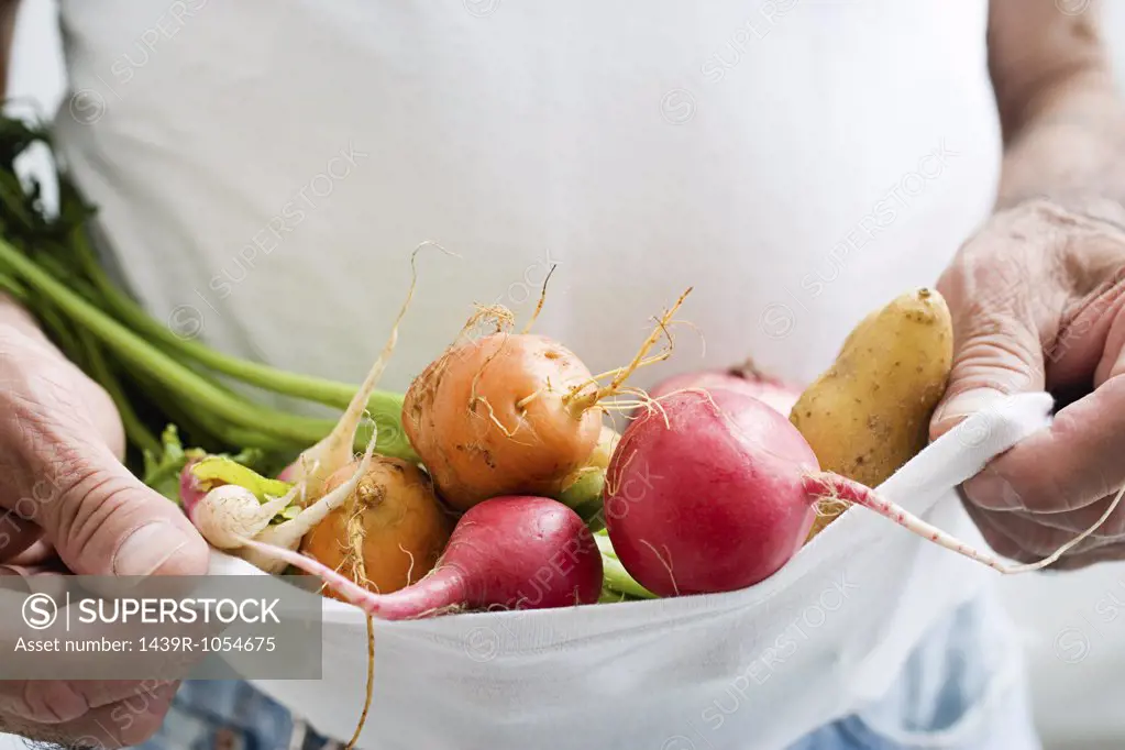 Man carrying vegetables in a t shirt