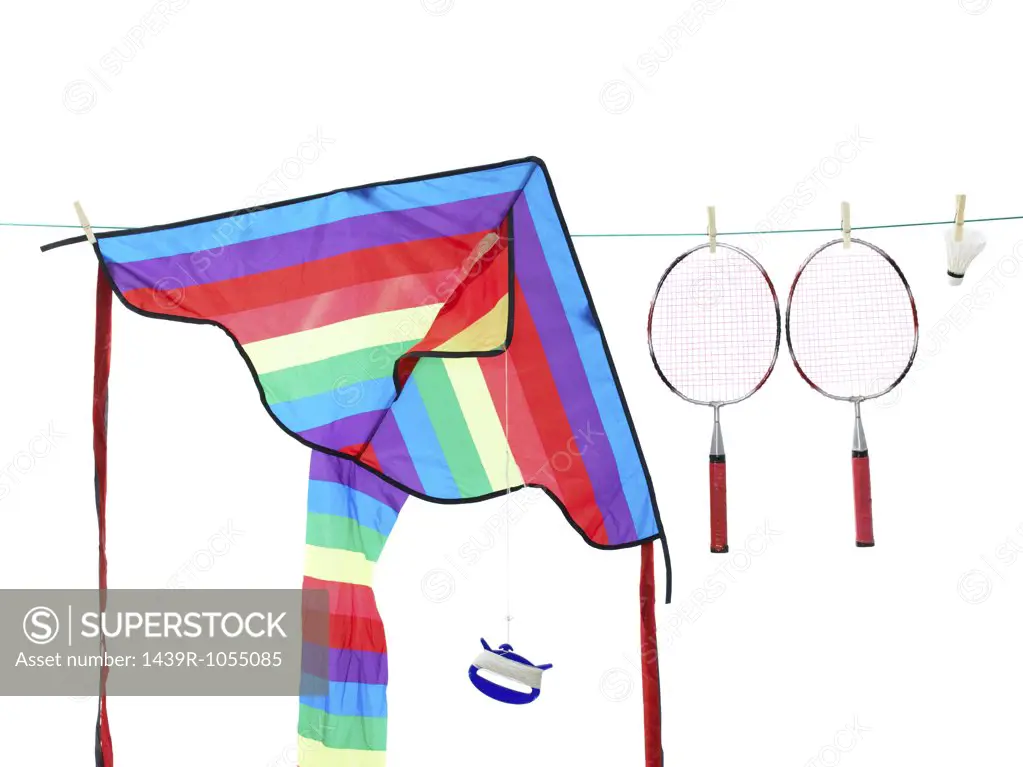 A kite and badminton rackets on a washing line