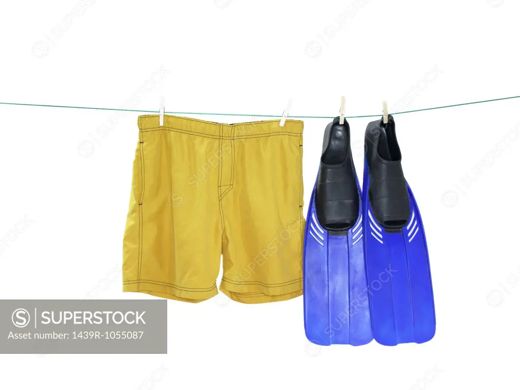 Swimming flipper and trunks on a washing line