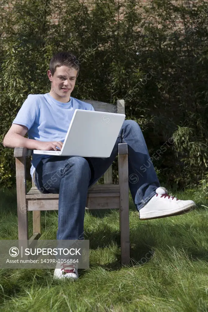 Teenage boy using laptop