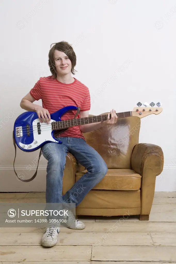 Teenage boy playing guitar