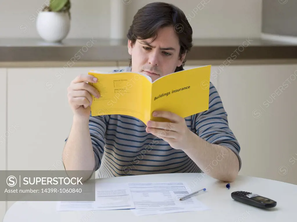 A man reading an insurance leaflet