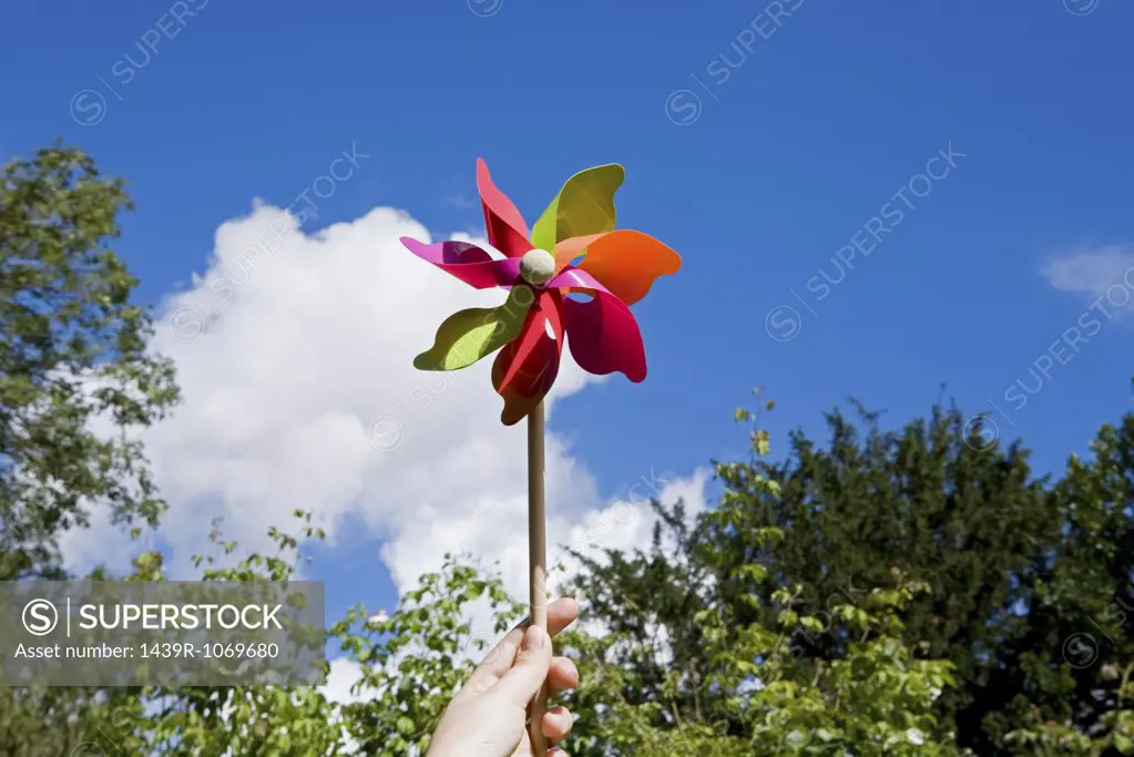 A person holding a pinwheel