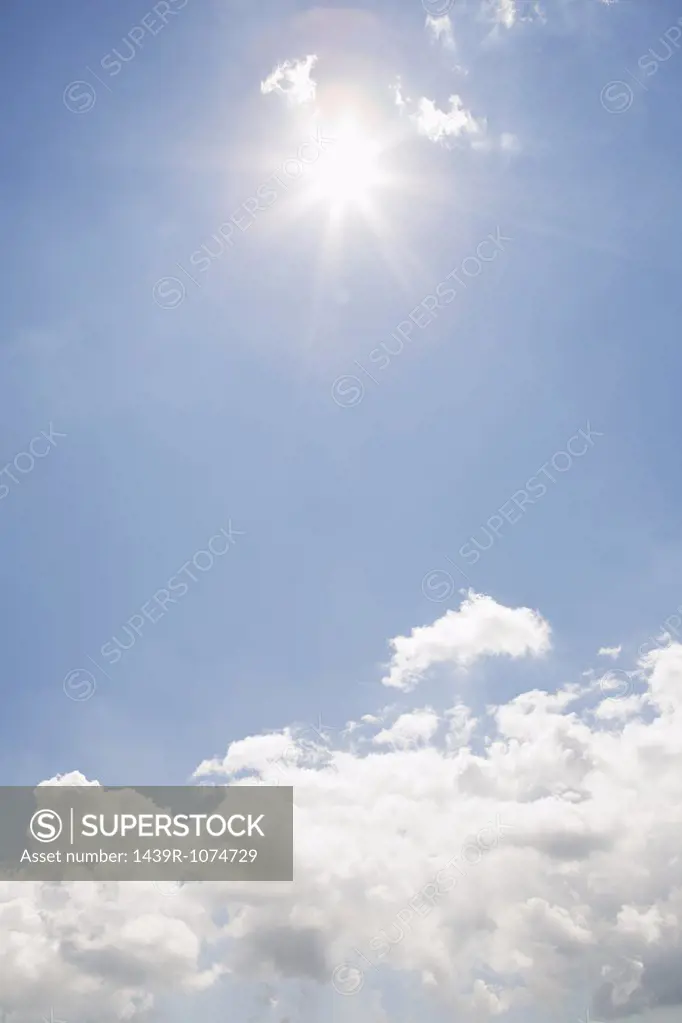 The sun and clouds in the sky