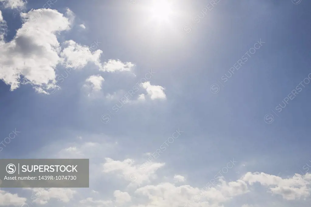 The sun and clouds in the sky