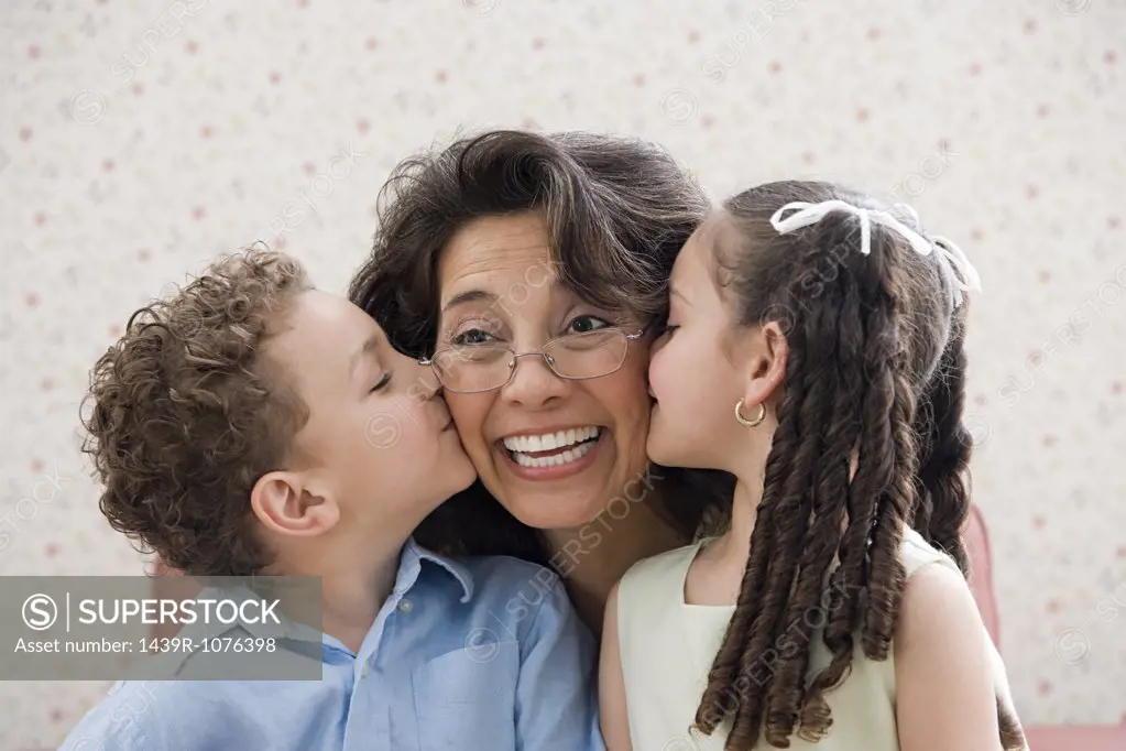 Kids kissing grandmother