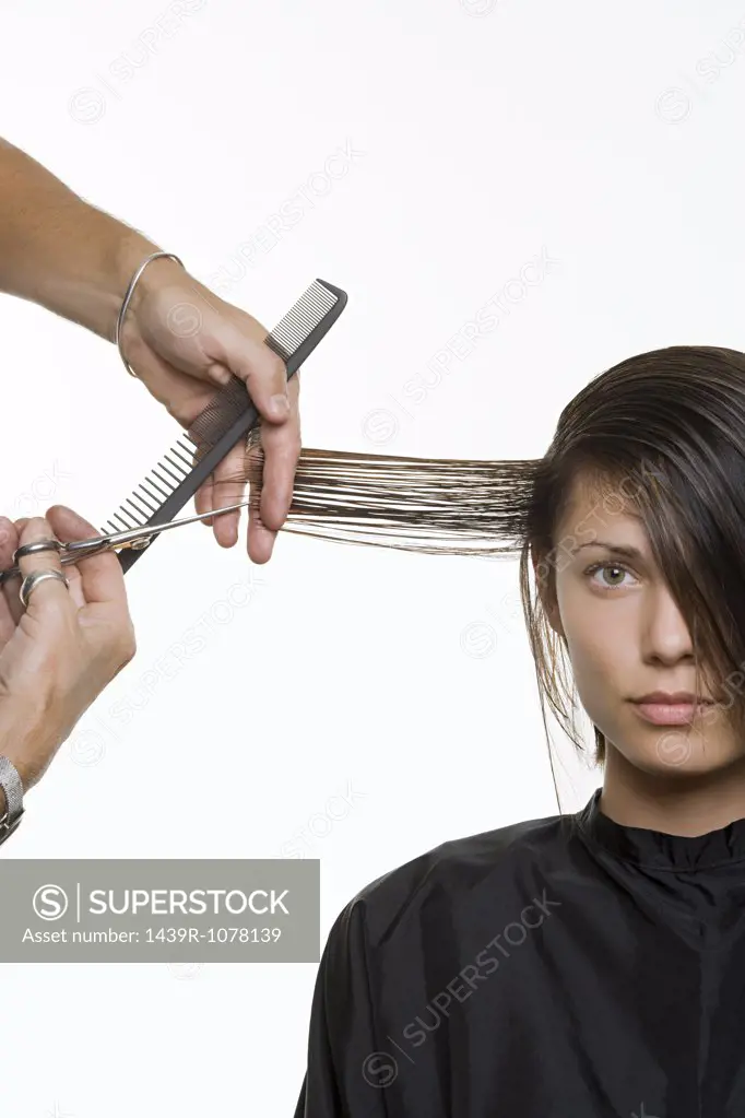 A woman having her hair cut