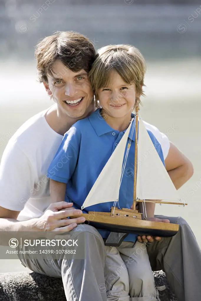 Father and son with toy boat