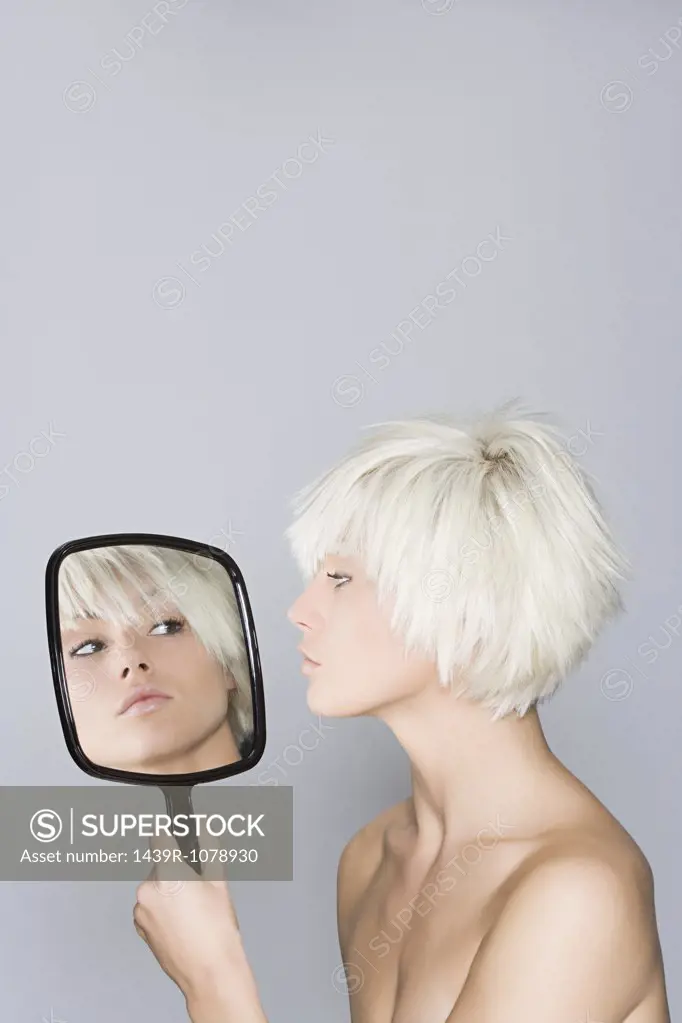A woman looking at her reflection